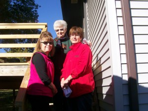 Kris Carrick (bottom, left) with her sister Jan Whitver and her mother Karma Hennigar (top) on the steps of her rehabilitated deck