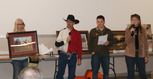 Artist Jodi Kopecky (right) painted and donated a pheasant scene to the Greene County Pheasants Forever chapter for the group's annual fundraising dinner and auction. Also pictured are (from left) Ashley Kuhl holding the painting, auctioneer Kevin Lentz and Pheasants Forever regional director Jared Wiklund.