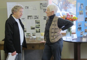 Doris Brown talks with Jean Borgeson (right) in front of display boards Borgeson compiled.