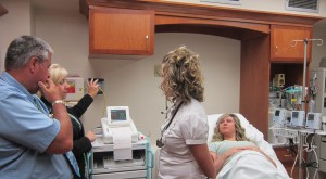 Dr David Jaskey and certified nurse midwife Valerie Martin of Advanced Women's Care receive training on the new fetal monitors in the obstetrics department. Advanced Women's Care patient Lacey Binkley looks on.