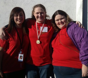 Gold medalist Rylie Breheny (center) with Makayla Murray (right) and volunteer Nicole Burton.