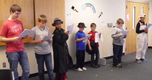Presenting a readers' theater are (from left) Nathan McKim, Evan Woodruff, Ti-Rone Bingley, Jayden Carstensen, Jax Carstensen, Dylan Smith and Terence Bingley. Hidden in the photo is Andrew McKim.