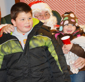 Gavin and Lily Trecker were happy to see Santa Claus in Scranton Dec. 5.  Photo by Scranton Journal