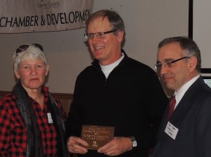 Chris Durlam (center) accepts a plaque recognizing 65 years of Chamber membership from Chris Henning and Ben Yoder