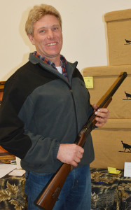 Dean Pudenz won a 410/22 rifle in one of the games at the Greene County Turkey banquet Saturday.  Photo|Scranton Journal
