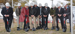 The first group to put shovels to the ground in the ceremonial groundbreaking were (from left) Bill Menner of USA Rural Development, trustees Doug Hawn, Judy Sankot, David Hoyt (partially hidden), Jim Schleisman, Kim Bates, medical center CEO Carl Behne, trustees Ralph Riesdesel and Bill Raney, Arnold Thomas of the USDA and Caleb Stockton of Stockton Facilities Mgt.