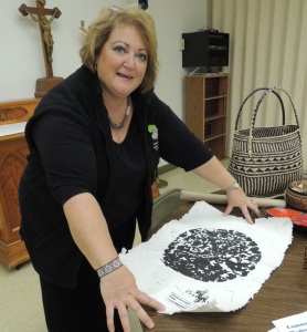Jean Feldmann shows an elephant footprint on handmade paper. The natives make and sell the paper and prints to tourists. 
