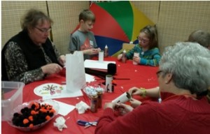 Donna Smith and Sandy Drewry help make mini-Olaf characters.