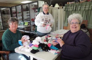 RSVP 55+ volunteers Barb Potkonak (left) and Carol Zwicky (right) sorted socks with Jackie Souder (center) before taking them to New Opportunities.