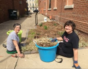 Deb Kucerak (left) and Shelly Berger prepare Sally's Alley for spring