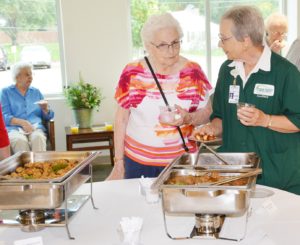 Auxiliary member and hospital trustee Judy Sankot (right)serves refreshments to Jean Fountain