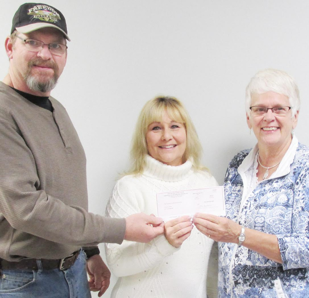 ICAP agent Joan St Clair (right) presents a check for $1,000 to Scranton mayor Randy Winkelman (left) and Scranton city council member Julie McAleer. | Scranton Journal photo